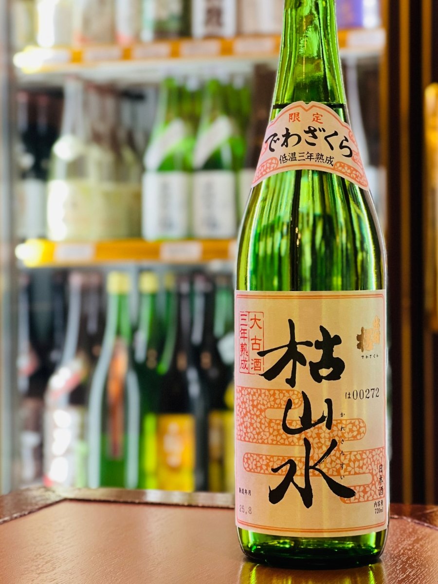 山形・出羽桜酒造の熟成酒「三年熟成大古酒 枯山水」720ml。白地に淡いピンクで彩られたの和風ラベルが貼られた緑ボトル。3年間の低温熟成を経て、カラメルや黒糖を思わせる上品に枯れた香りと、ザラメが溶け込んだようなまろやかな甘みが特徴です。常温やお燗でより一層引き立つ、揚げ出し豆腐やつぶ貝の煮付けにぴったりの絶品食中酒です。