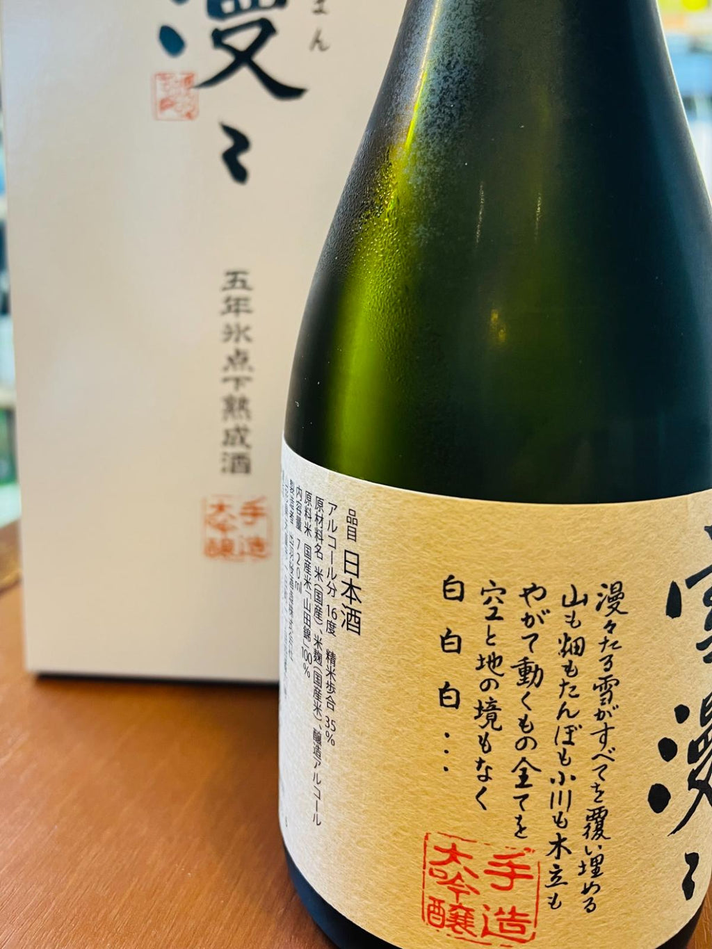 出羽桜 雪漫々 氷点下五年熟成酒 720mlの瓶側面。山形県天童市・出羽桜酒造が山田錦を100％使用し、35％まで磨いて醸すアルコール16度の大吟醸酒。ラベルには「漫々たる雪がすべてを覆い埋める」と始まる雪漫々の銘文と商品スペックを記載。