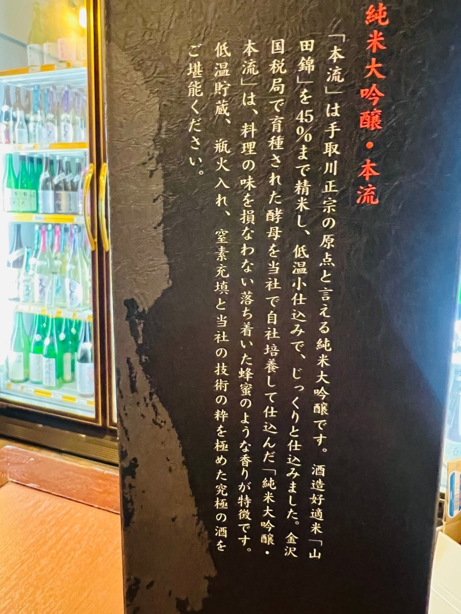 手取川 純米大吟醸 本流 720ml 化粧箱の側面デザイン。酒の説明文やコンセプトが縦書きで記された黒いギフト箱の側面。