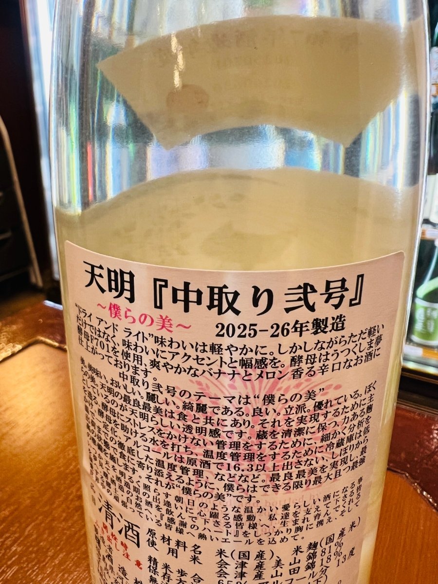 福島・曙酒造「天明（てんめい）中取り弐号」の裏面ラベル詳細。「僕らの美」をテーマに、蔵を清潔に保ち、酵母にストレスをかけない徹底した温度管理のもとで醸された情熱が記されています。「ドライ アンド ライト」を掲げ、会津産山田錦（50%精米）と会津産美山錦（65%精米）をブレンド。うつくしま夢酵母F701が醸し出す爽やかなバナナとメロンの香りと、食に寄り添う透明感を追求した、最良最美な酒造りの姿勢を伝える製品スペックです。
