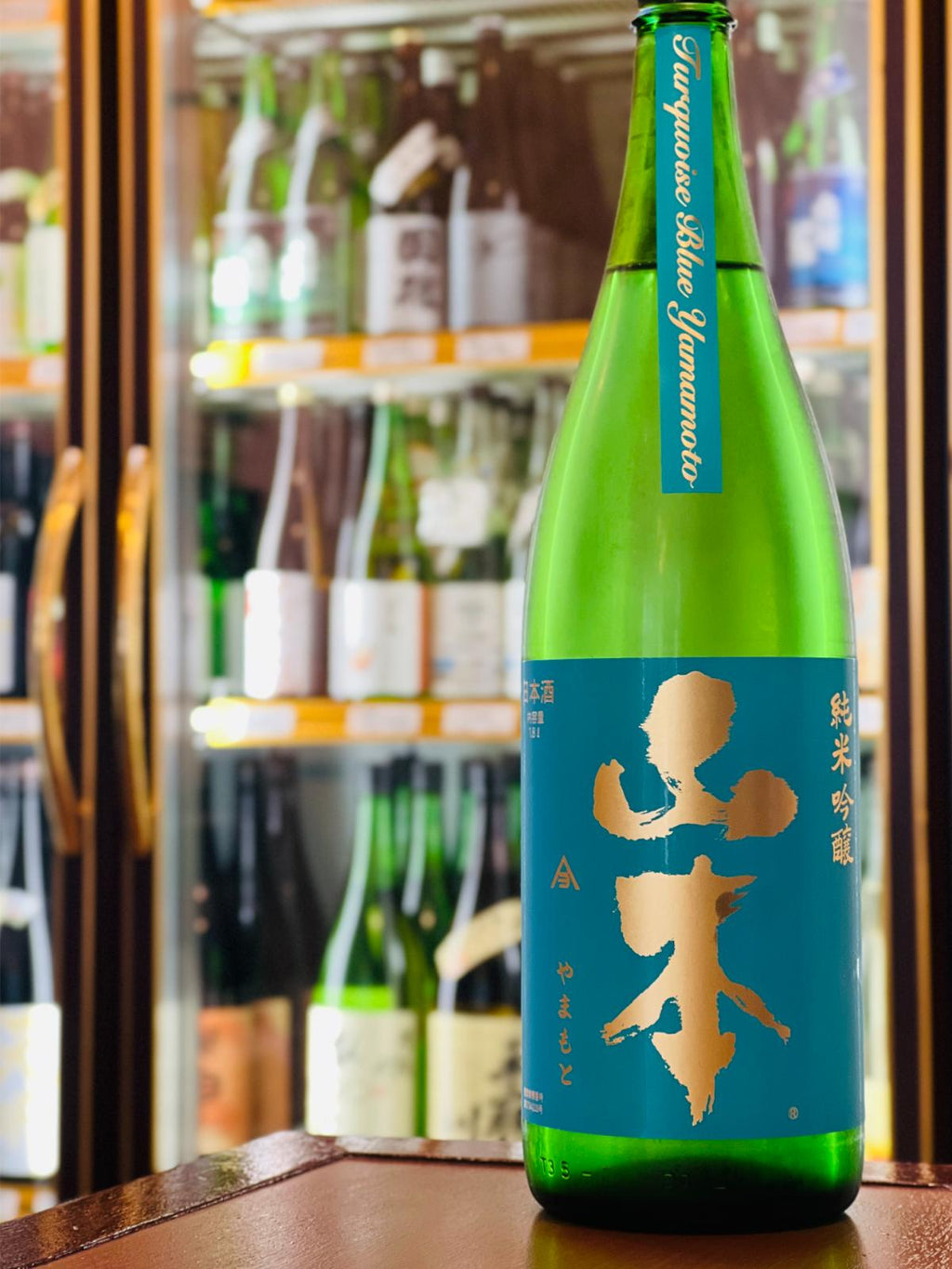 山本 純米吟醸 ターコイズブルー 1800ml。秋田県・山本酒造が能代市二ツ井産の「改良信交」を使用して醸す純米吟醸。フレッシュな柑橘を思わせる香りと、ほのかな甘み、心地よい酸、すっきりした後味が特徴。コスパに優れた一升瓶サイズ。
